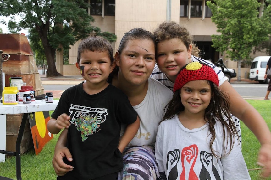 Kirra Voller, one of the organisers of the Alice Springs Invasion Day rally is pictured with her children.