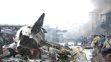 Rescue workers sift through the wreckage of a crashed passenger plane in Indonesia.