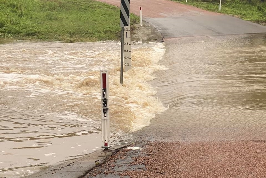 Water rushing over the road of Black Gully Crossing on Woodstock Giru Road.