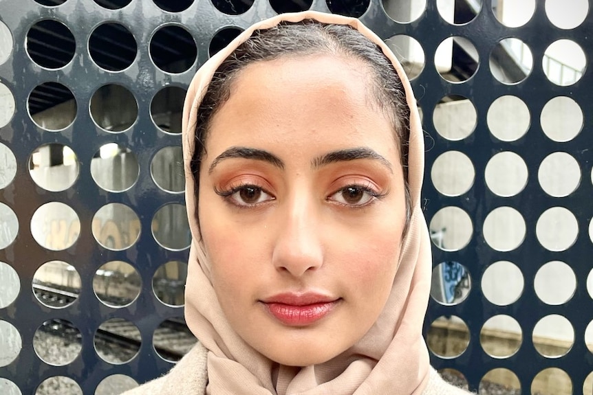 A head and shoulders photo of Anhar Al-Shameri looking at the camera and wearing her hijab.