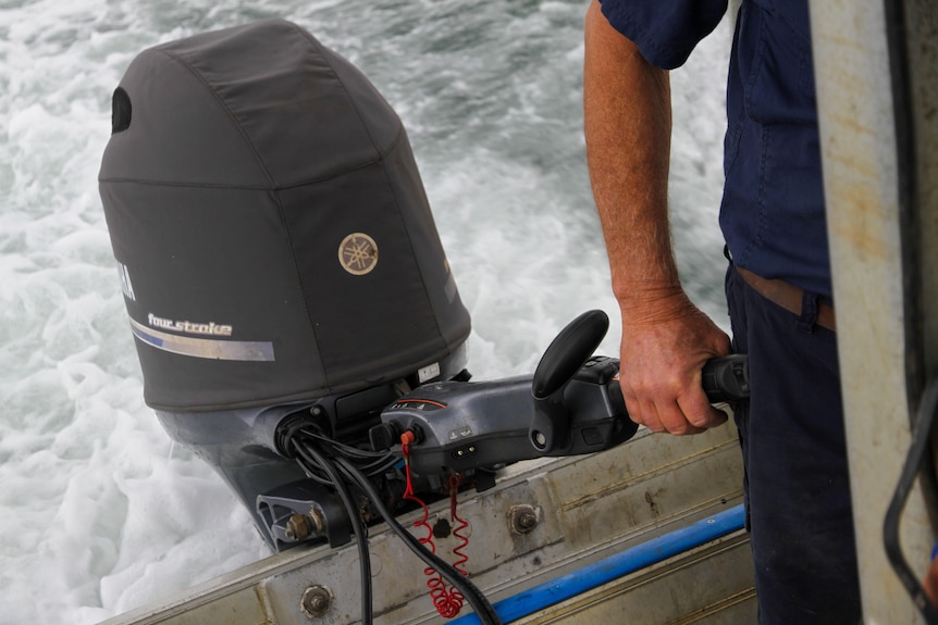close up of a boat's outboard engine being operated