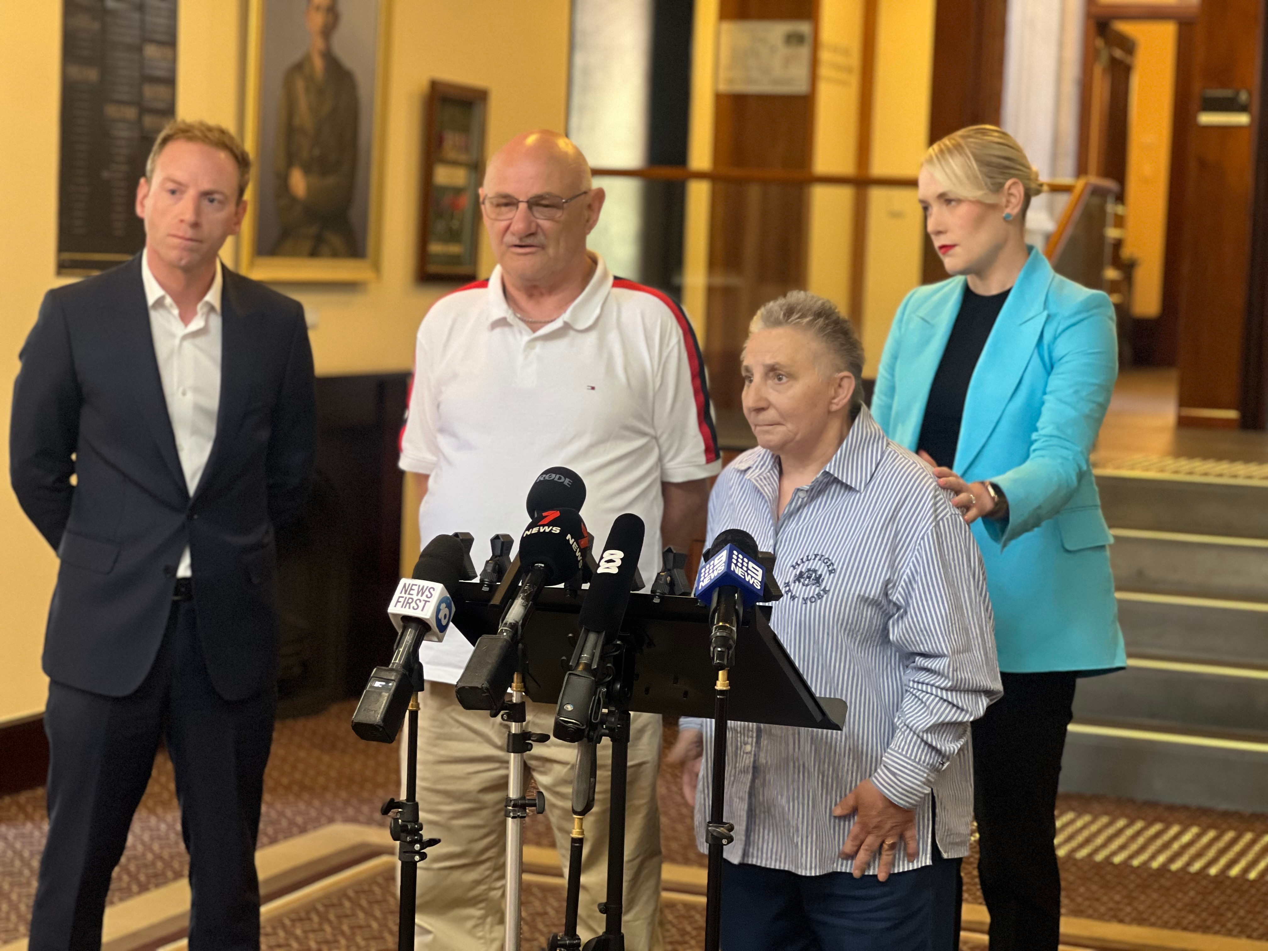 people standing infront of microphones