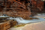 A close of the Karijini gorge and the water running through.