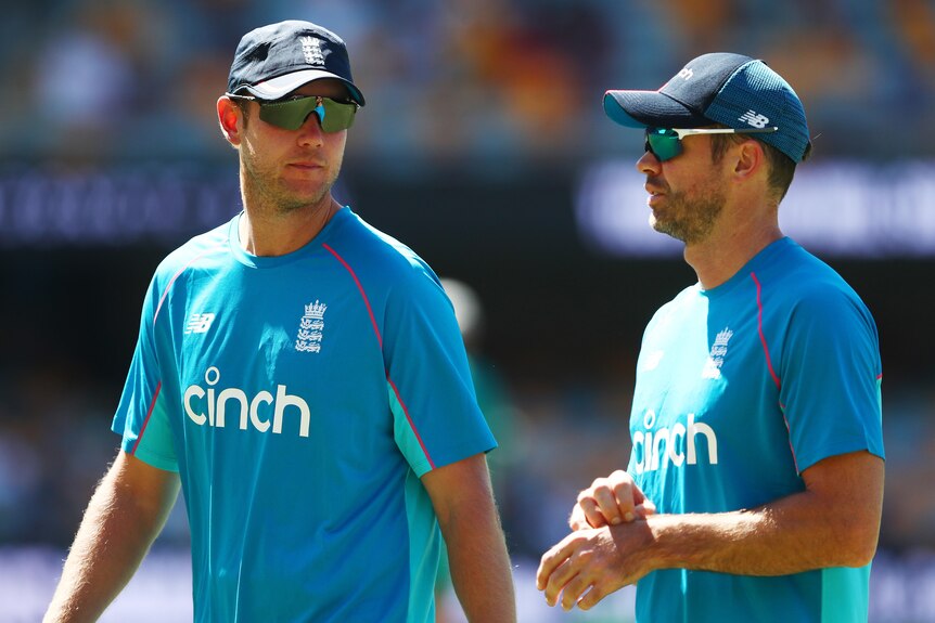 Stuart Broad and James Anderson speak during warm up ahead of day four of the First Test