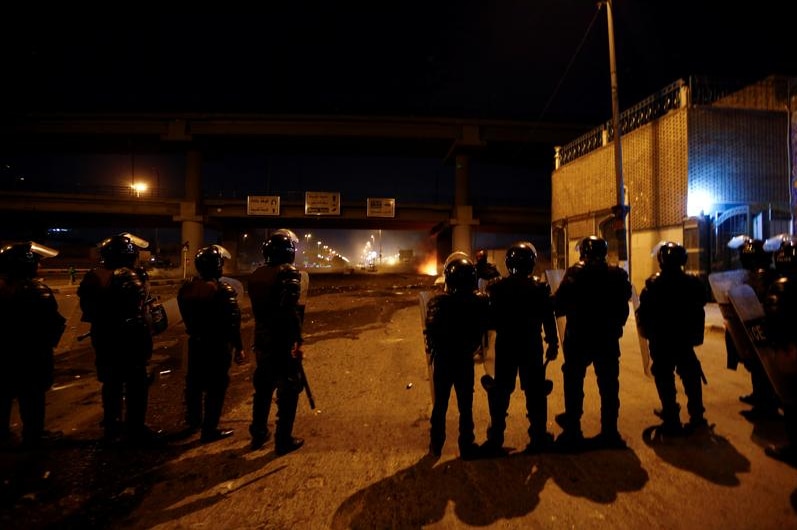 Secuirty forces on the road at night in Iraq.