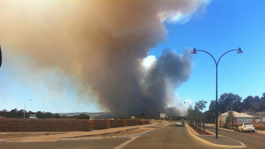 Smoke rises from a bushfire burning at Bullsbrook
