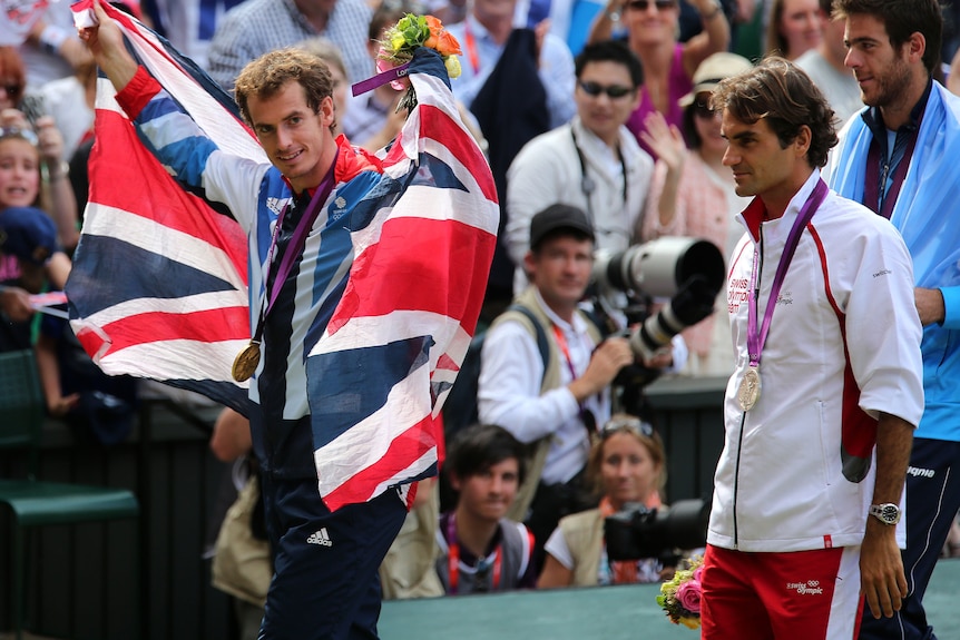 Andy Murray after winning Olympic gold in 2012, he is wearing the medal and a Union Jack flag.