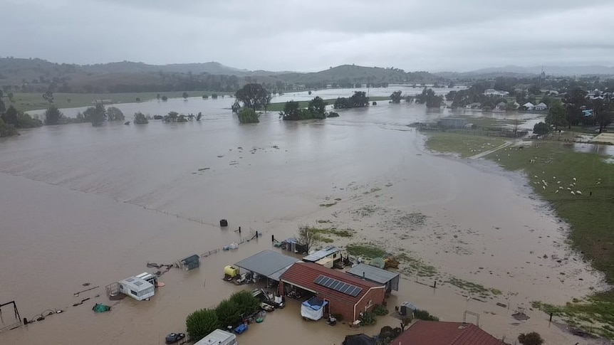 Drone view of floodwaters surrounding a home in Barraba