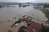 Drone view of floodwaters surrounding a home in Barraba