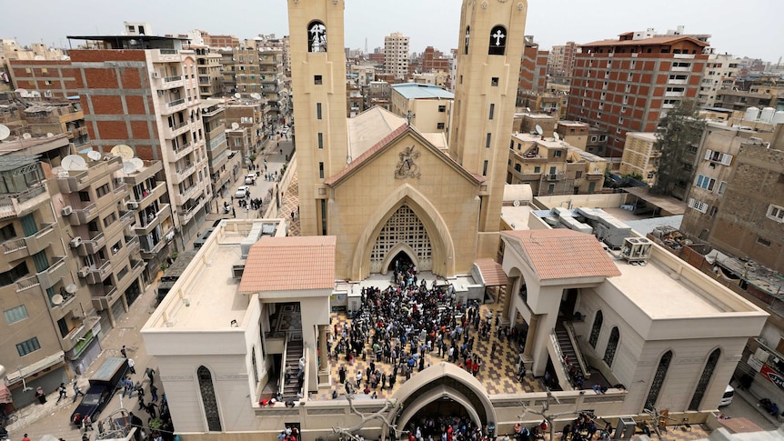Egyptians gather by a Coptic church after it is bombed in Tanta, Egypt.