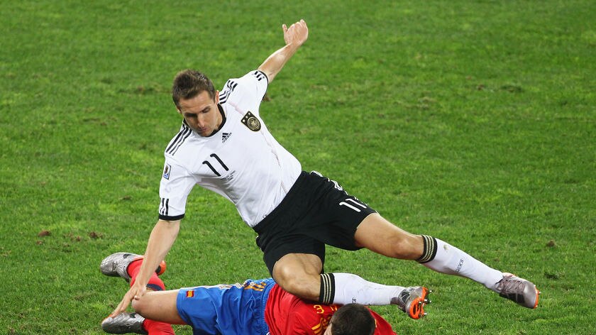 Tight tussle: Miroslav Klose and Gerard Pique fight for possession.
