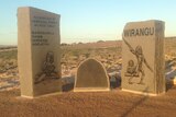 A Indigenous memorial made of stone in a desert setting.