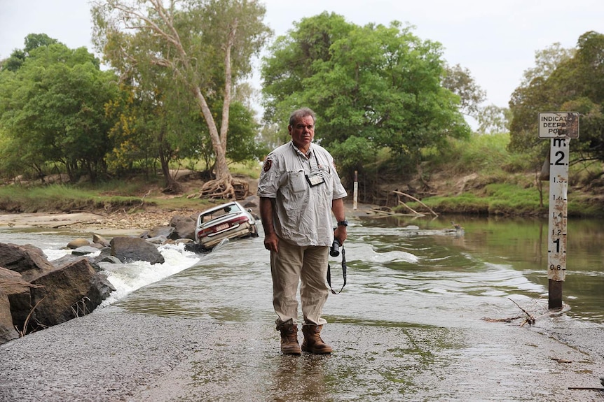 A photo of Gary Lindner standing near the water at Cahill's Crossing.
