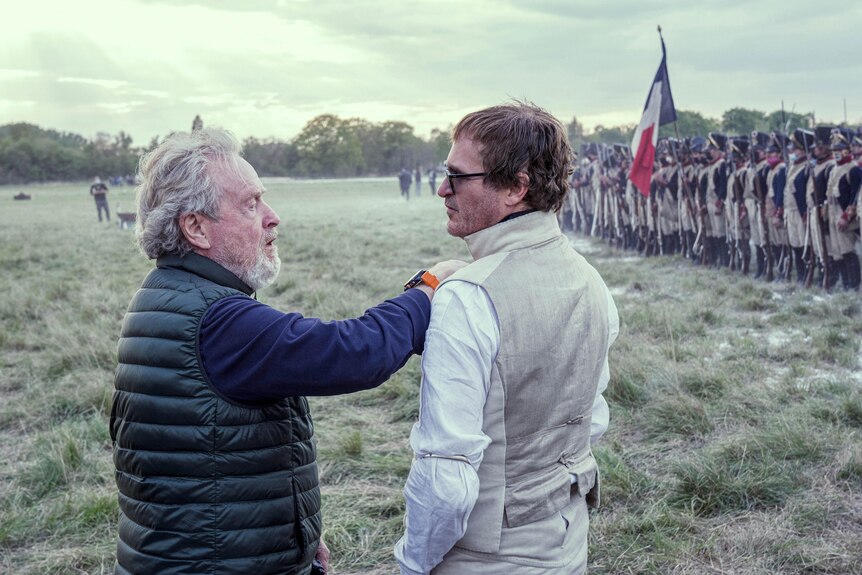 Director Ridley Scott and actor Joaquin Phoenix on set shooting an outdoor battle scene for the film Napoleon.
