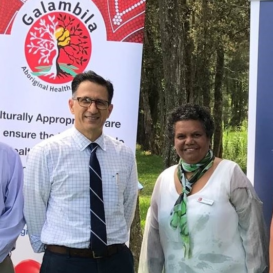 North Coast Primary Health Network and Galambila Aboriginal Health Service CEOs standing in front of banner at Coffs Harbour