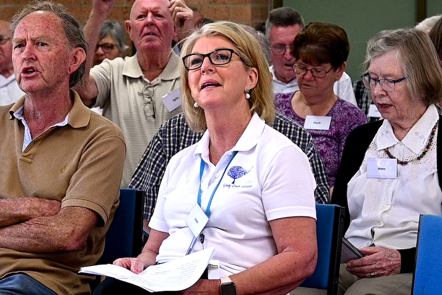 A woman singing in a crowd