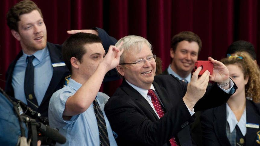 Kevin Rudd poses for selfie with a student at St Columan's College in Caboolture.