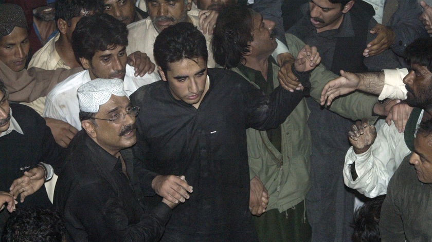 Asif Ali Zardari (with white cap), husband of assassinated opposition leader Benazir Bhutto with their son Bilawal leave after her burial in Garhi Khuda Bukhsh on December 28, 2007.