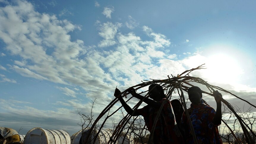 Somali refugees build a makeshift shelter in an extension to the Dadaab camp.