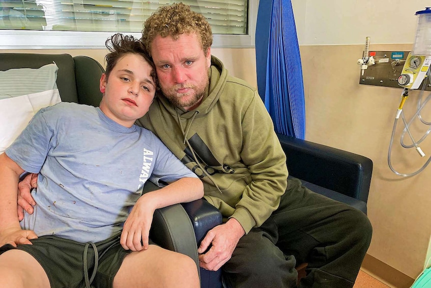 A boy and a man on a sofa in a hospital