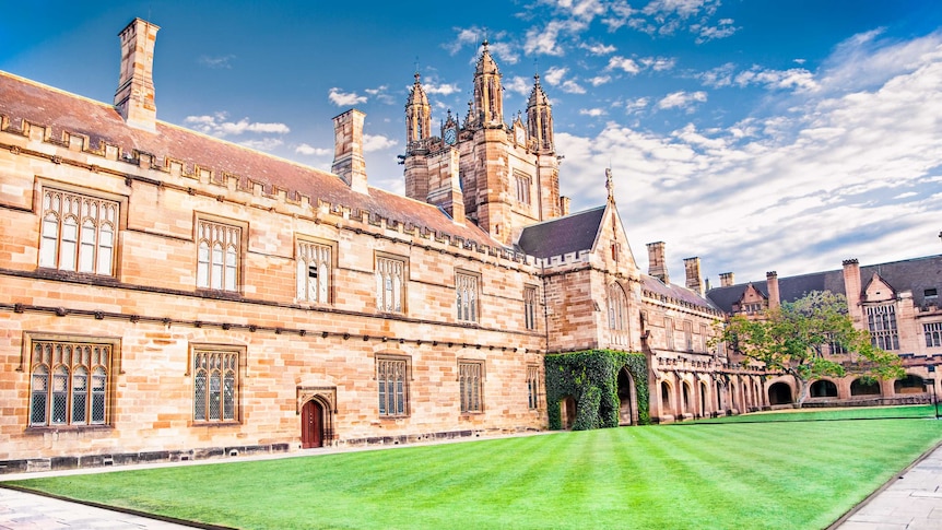 grand sandstone building with blue sky