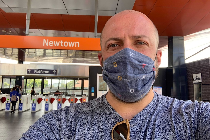Tyson Shine wearing a mask at Newtown train station in Sydney.