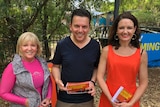 Two women with Nick Xenophon as the three smile for the camera.