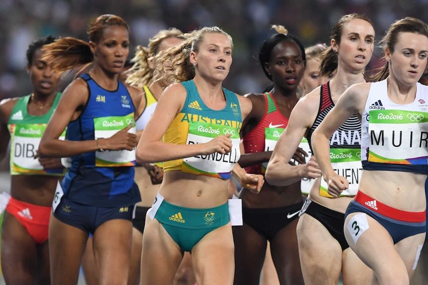An Australian runner holds her spot on the outside near the front in an Olympic 1500m semi.