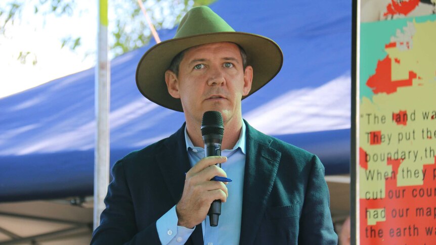 Chief Minister Michael Gunner holds a microphone