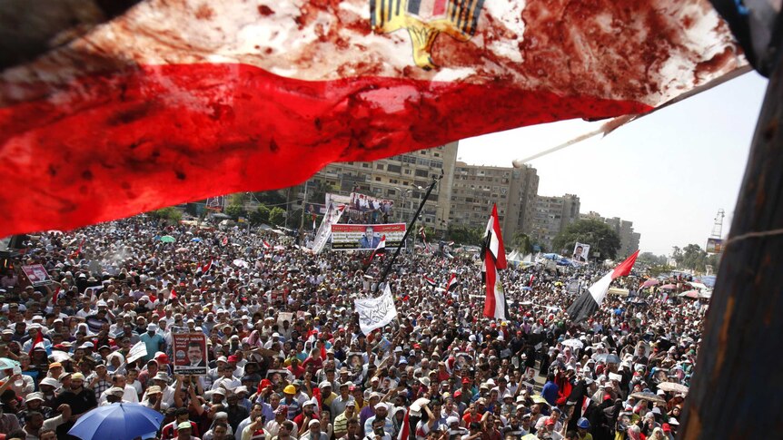 Blood-stained Egyptian flag flutters over protesters