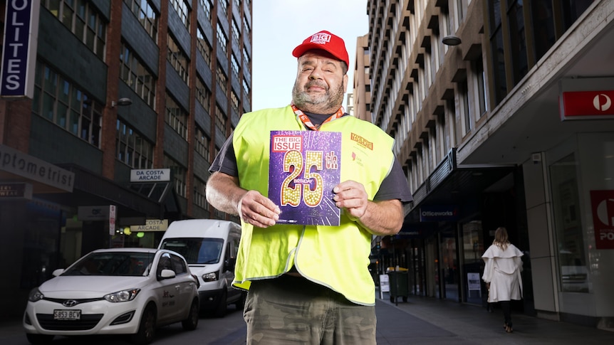 Vernon a Big Issue vendor holding the 25th edition.