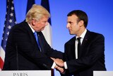 US President Donald Trump shakes hands with French President Emmanuel Macron
