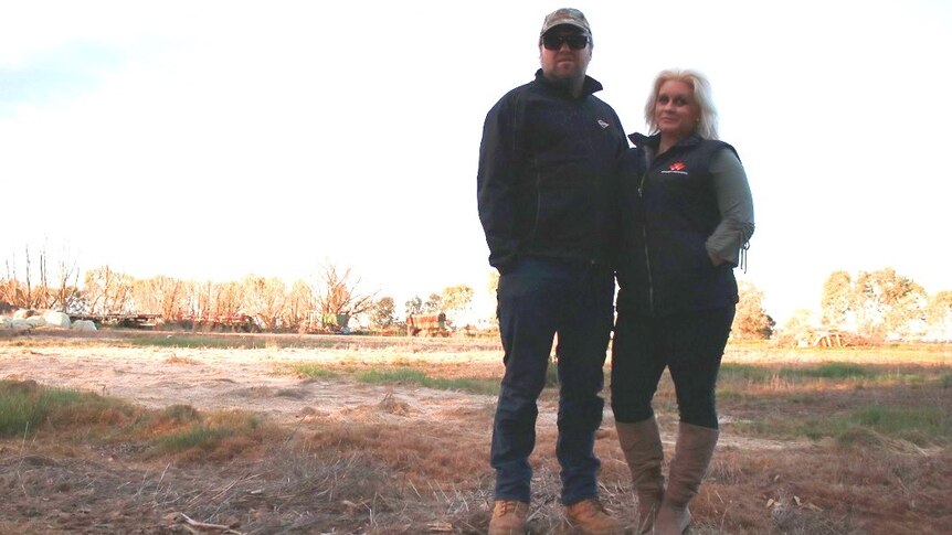 A couple stands on their drought-affected property in Victoria.