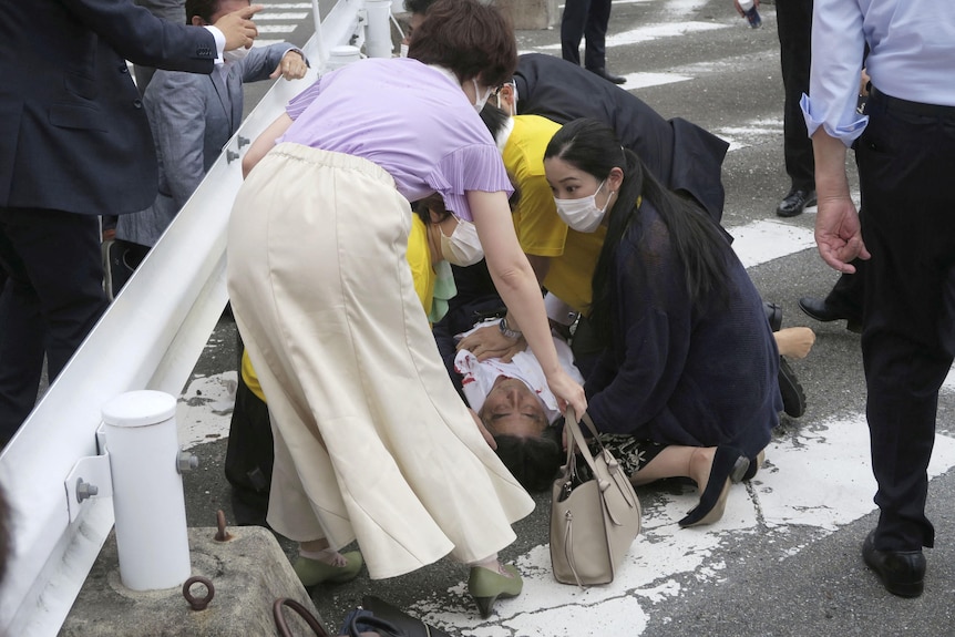 Shinzo Abe lies on the ground after apparent shooting during an election campaign