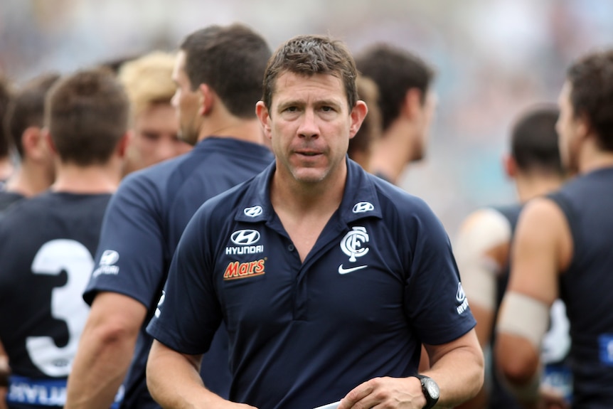 Carlton coach Brett Ratten leaves the field during a preseason game with Adelaide Crows in 2012.