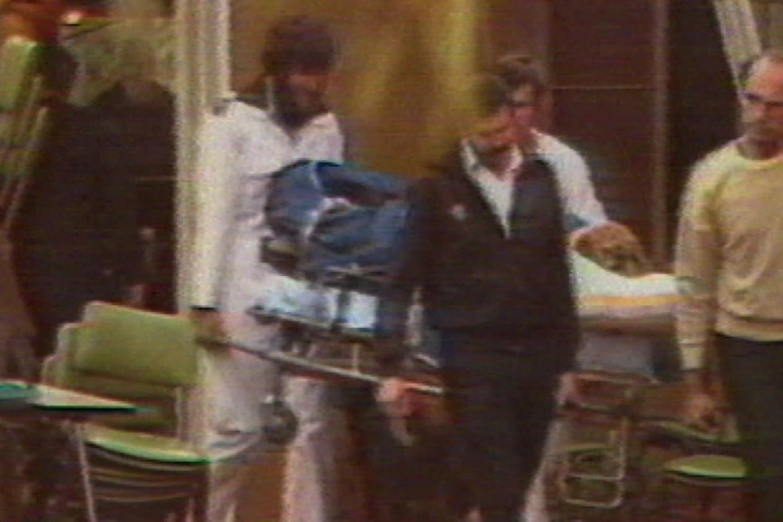 Inland hotel crime scene footage from ABC News showing someone being carried on a stretcher.