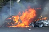 Two vehicles burn after they collided on a highway east of Bangkok.