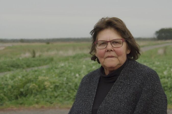 Indigenous woman Eileen Alberts stands in a field near her Victorian home.