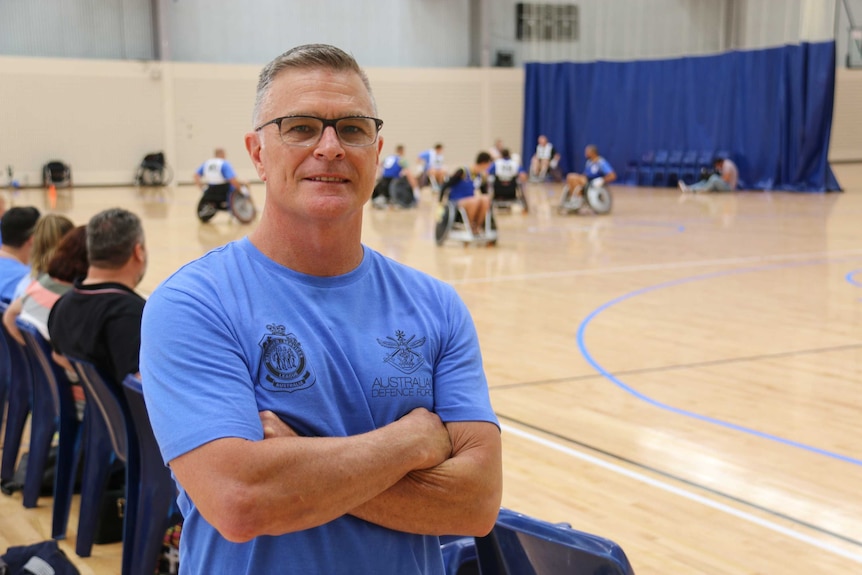 Australian Air Force warrant officer Tony Benfer stands in of the wheelchair rugby court.