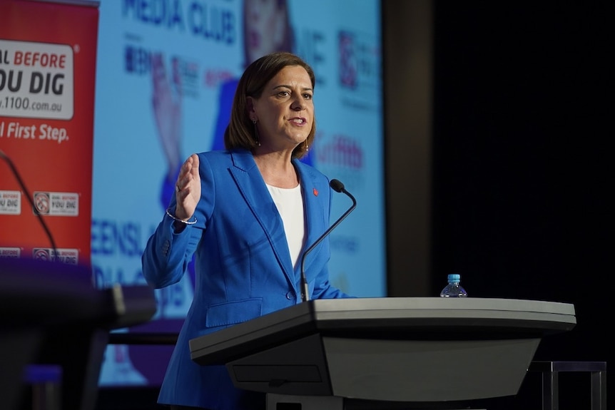 A woman speaks at a lectern.