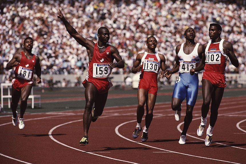 Canadian sprinter Ben Johnson raises his arms as he crosses the finish line at the 1988 Seoul games 100 metres race.