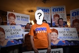 an image of silhoutte in front of One Nation campaign posters