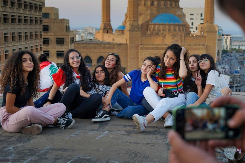 A group of young teenaged girls pose for a photo on a rooftop in Beirut