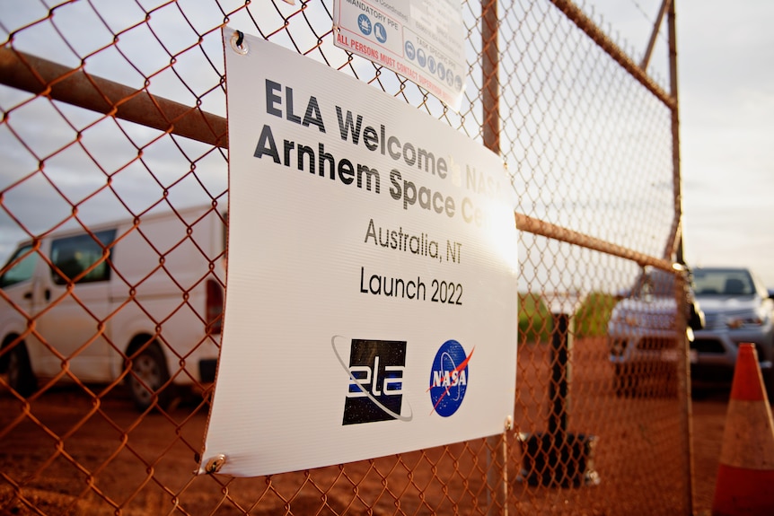 Sign reading Arnhem Space Centre in red dirt 