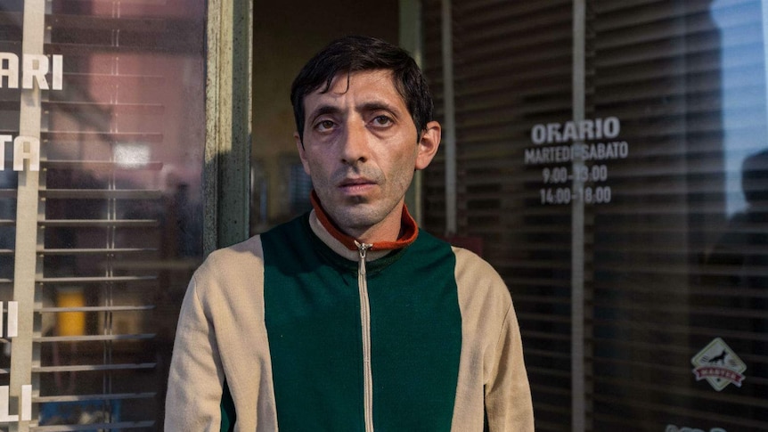 Wearing a battered and tired looking windbreaker, the actor stares desolately into the camera.