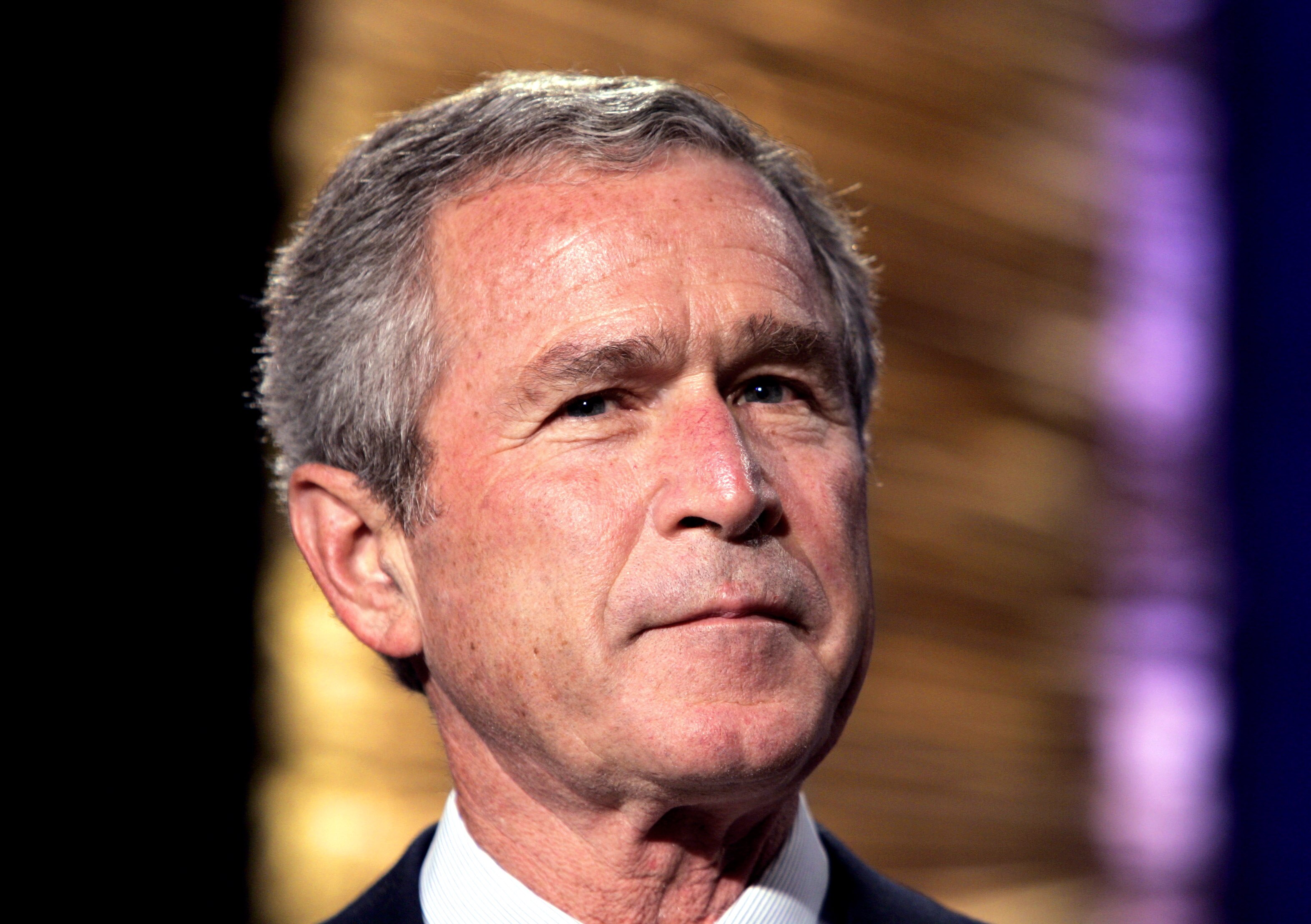 A headshot of George Bush with a serious expression