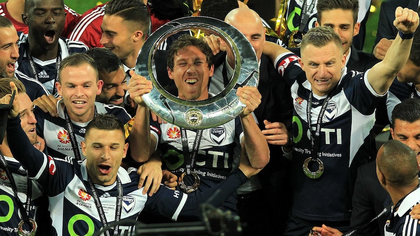Melbourne Victory celebrates with A-League trophy