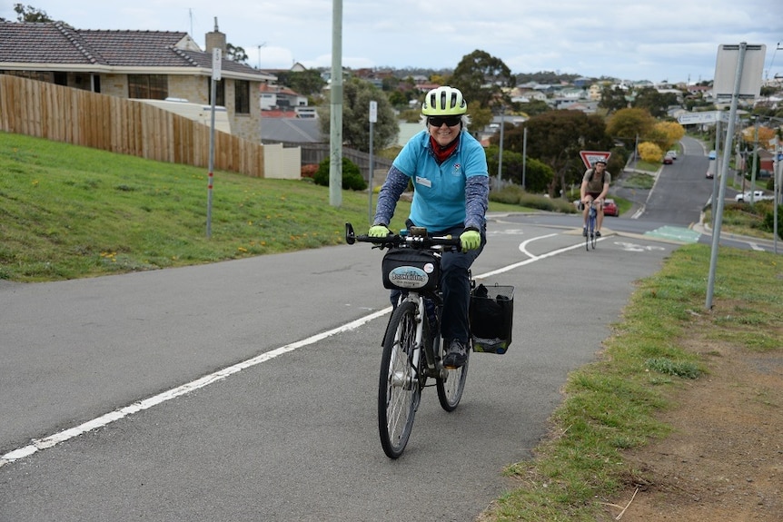 Female cyclist leading another on an unidentified road in Tasmania
