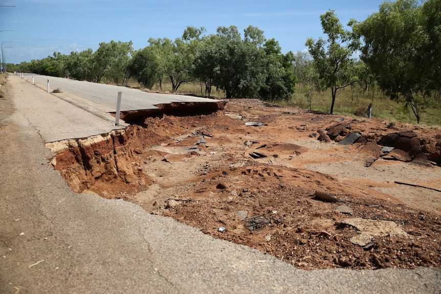 A severely damaged road.