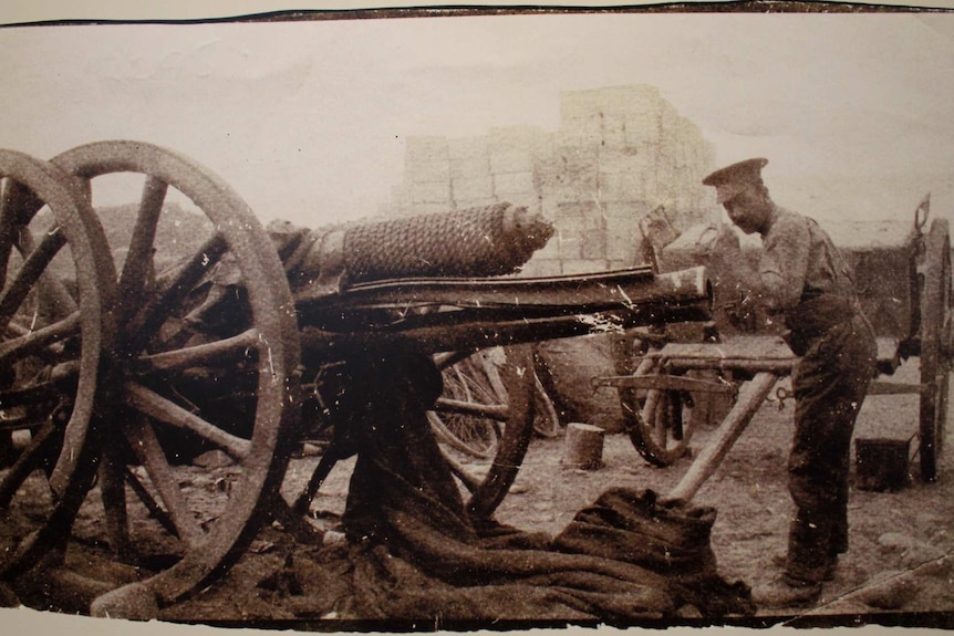 Soldier standing next to an 18 pounder long gun in Gallipoli, 1915, which has had the barrel split open by a misfire.